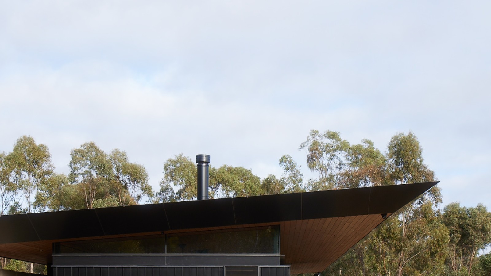 Contemporary dark-clad Australian house with deep roof
