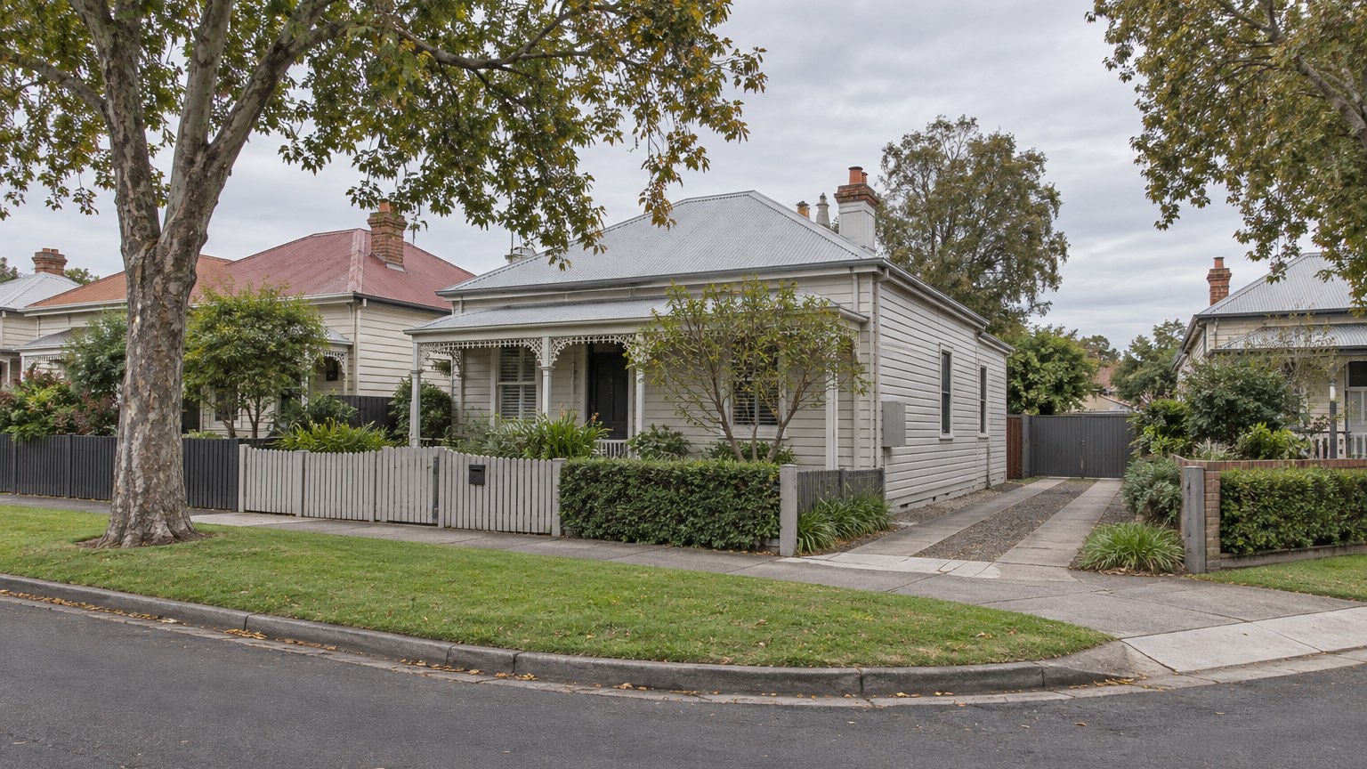 Weatherboard house on a corner block in an older suburban street